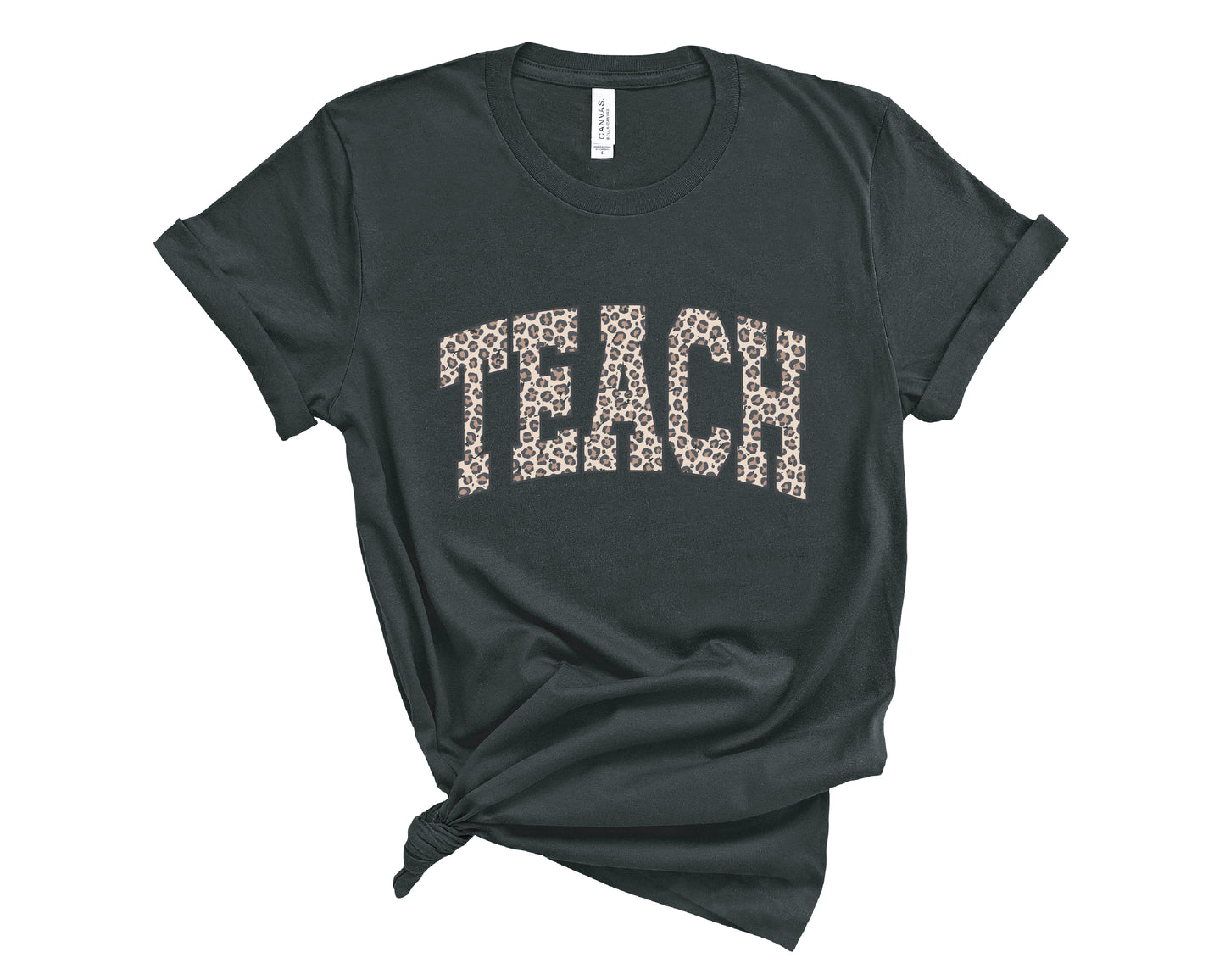 A black t-shirt with the word 'TEACH' printed across the chest in a leopard print pattern, styled with a knot at the bottom hem on a white background.